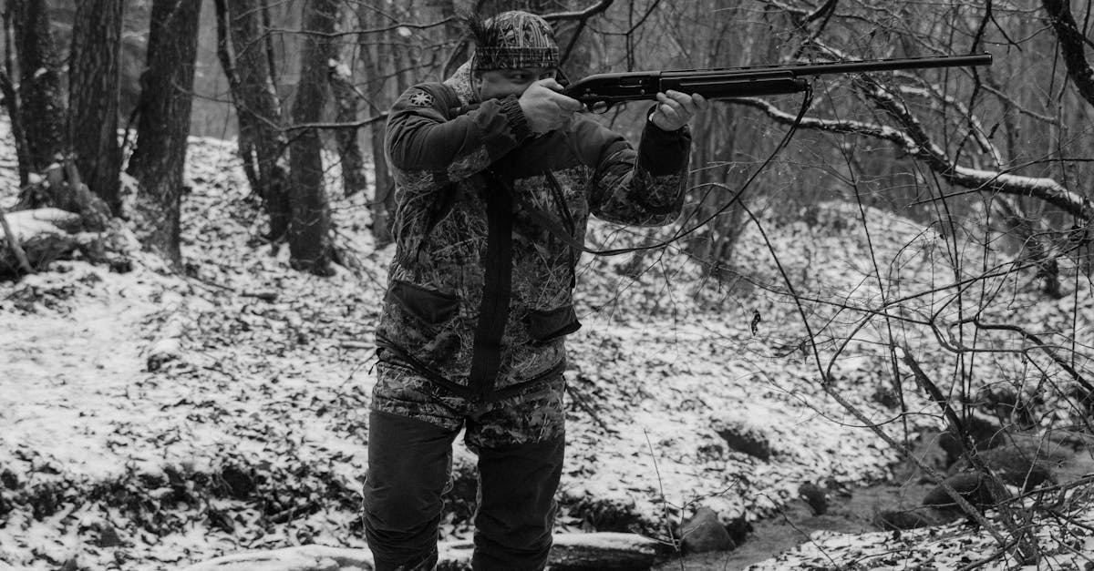 Man Walking While Aiming a Riffle · Free Stock Photo