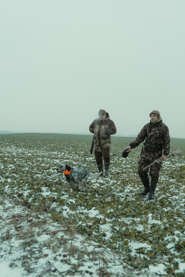 Two Men Walking With Dog 