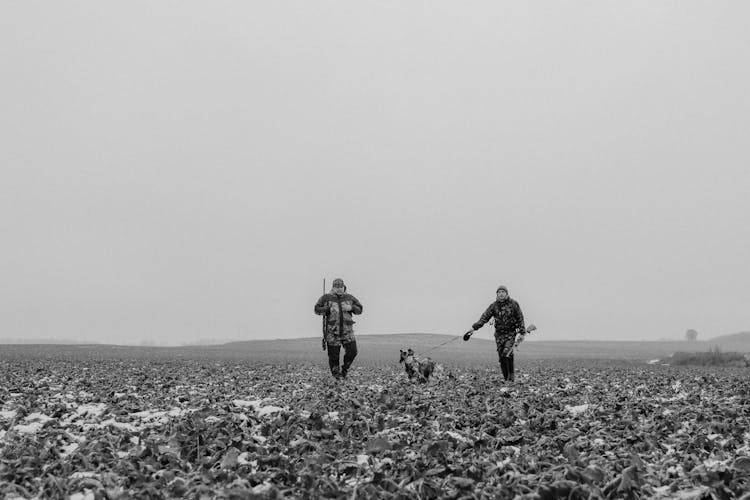 Two Men Walking With Dog 