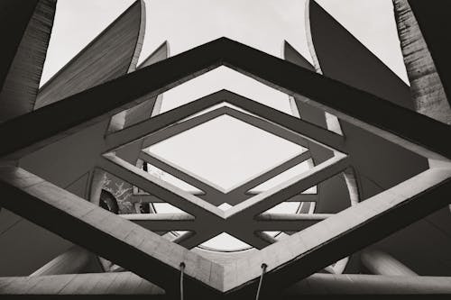 Grayscale Photo of a Ceiling of a Concrete Building