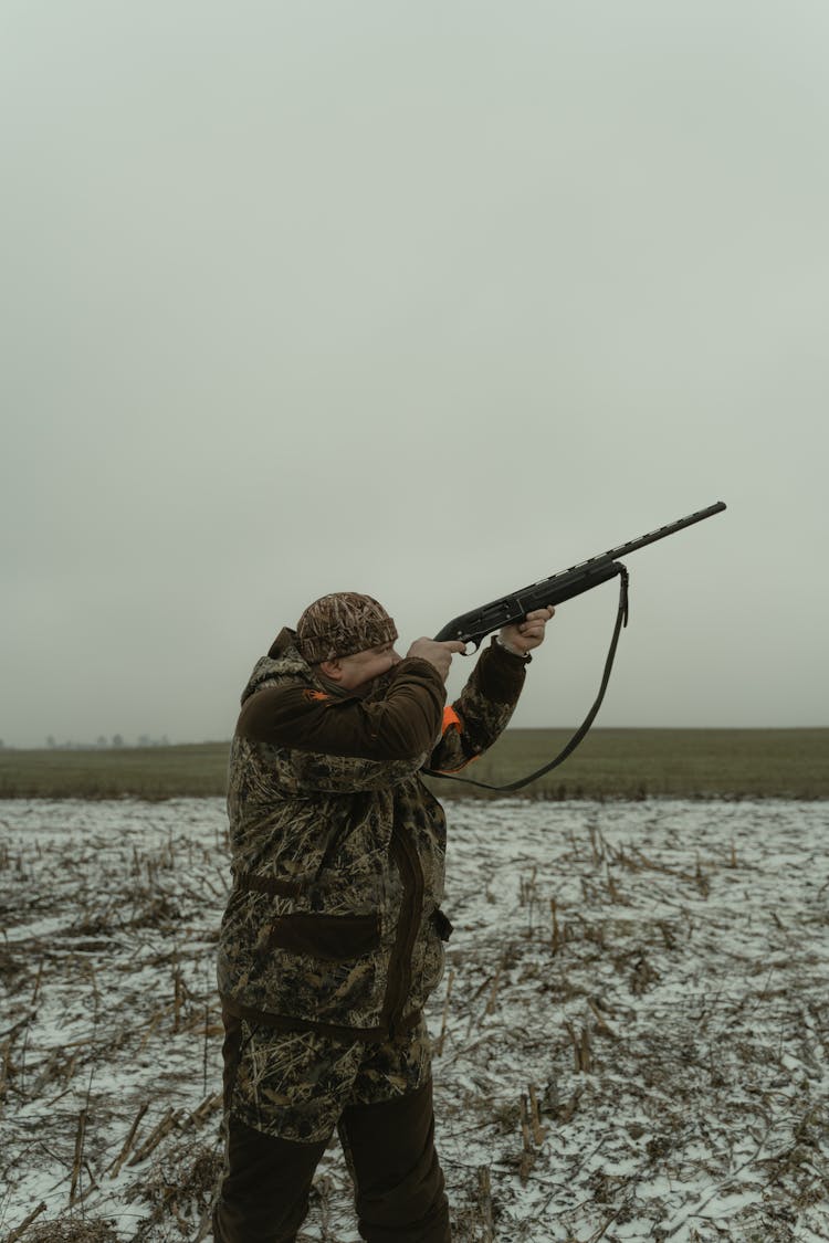 Man Aiming His Rifle In The Sky