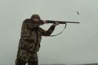 Photo of a Man Firing His Shotgun