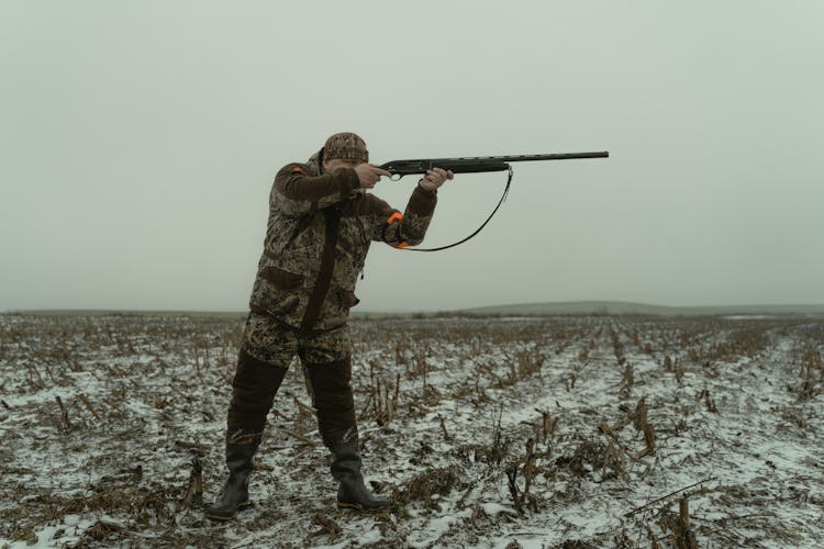 Man Shooting A Shotgun