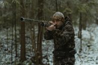 Photo of a Man Aiming a Shotgun