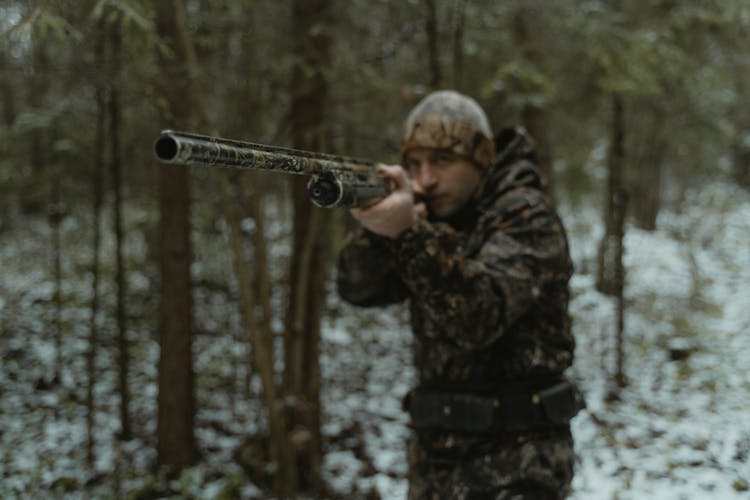 Photo Of A Man Aiming A Shotgun