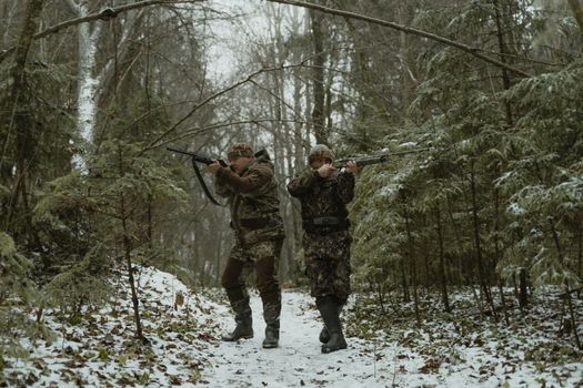 2 Men in Camouflage Uniform Holding Rifle Standing on Snow Covered Ground