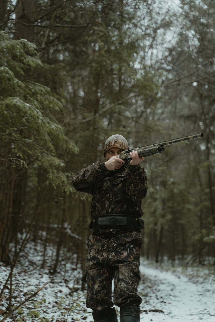 Man Shooting With A Rifle