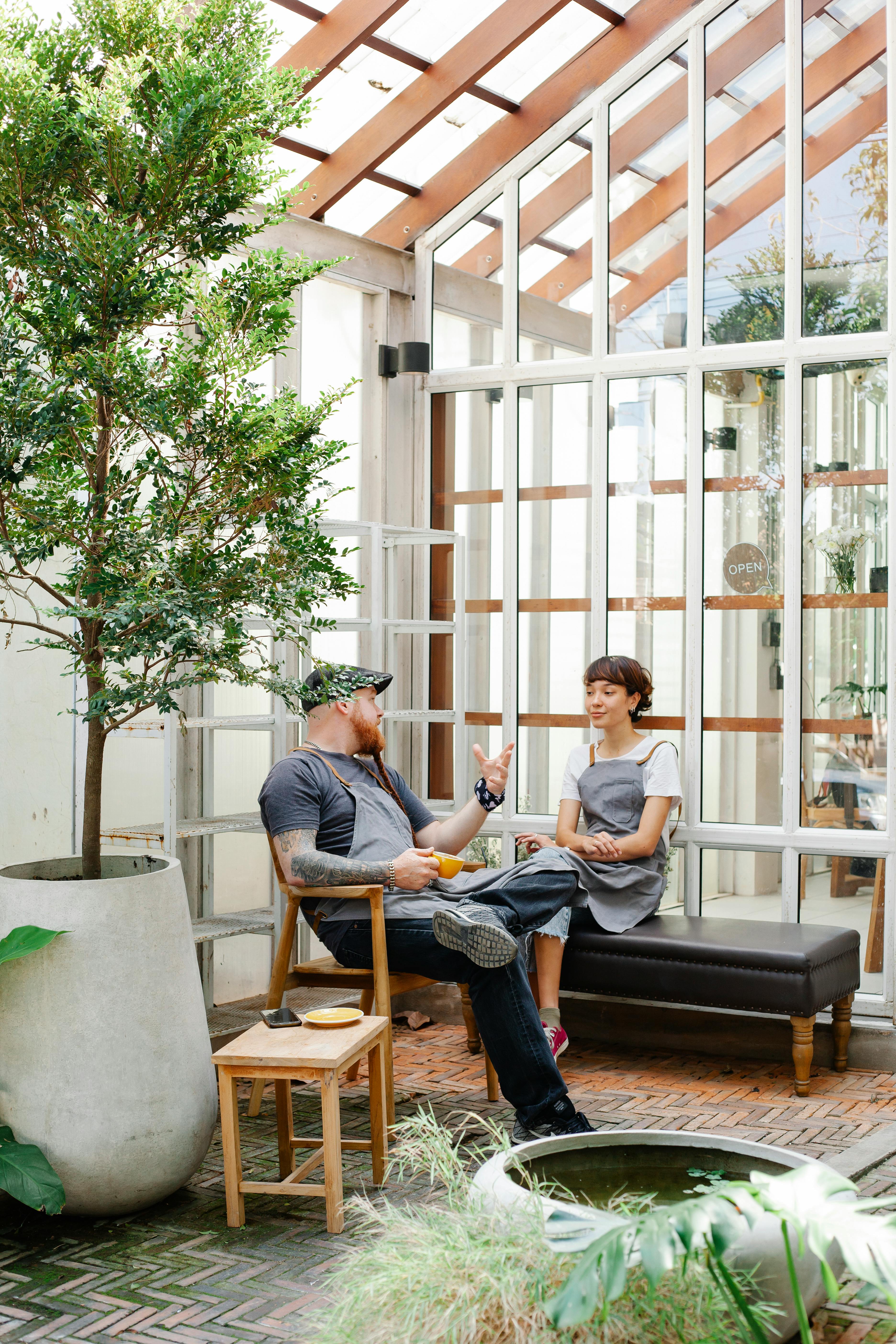 couple of coworkers talking in terrace in aprons