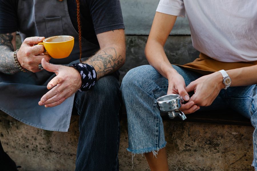 Two people talking outdoors on a street
