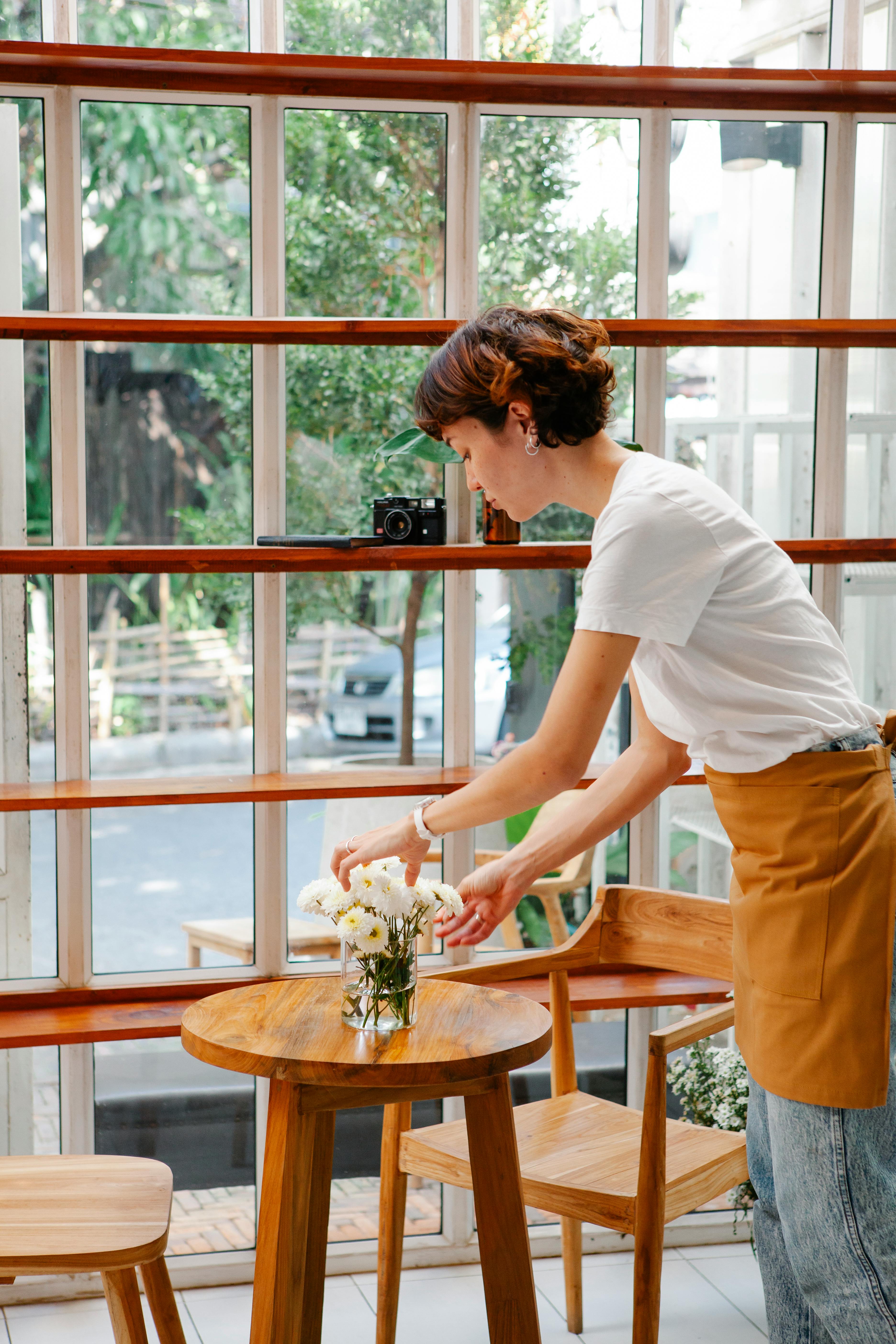 Free Female employee near table in cafeteria Stock Photo