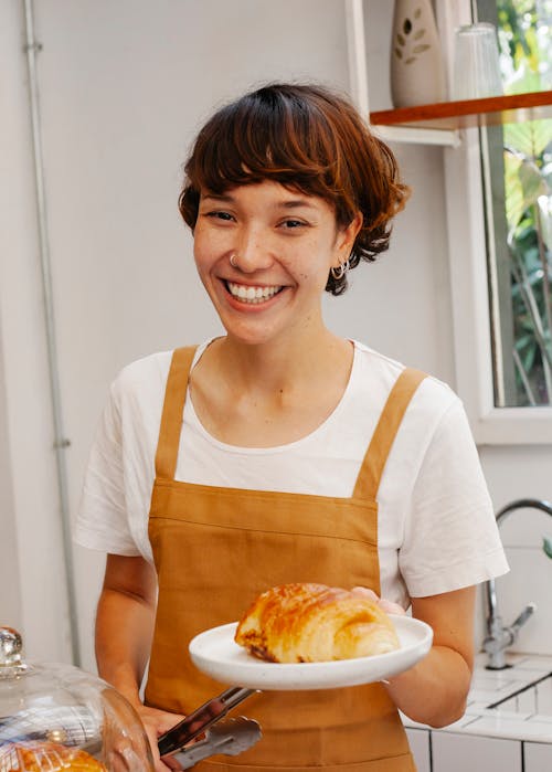 Content baker with delicious puff in cafeteria