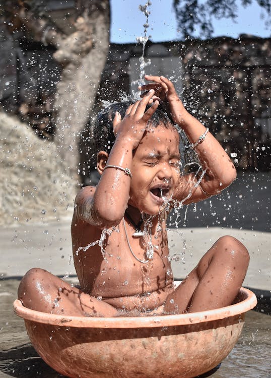 Girl Bathing while inside a Basin Free Stock Photo