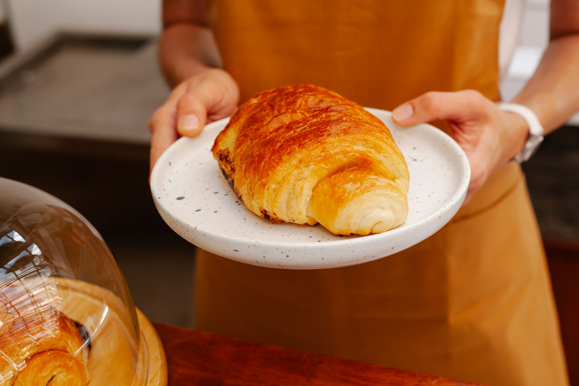 Crop baker with delicious puff in cafeteria