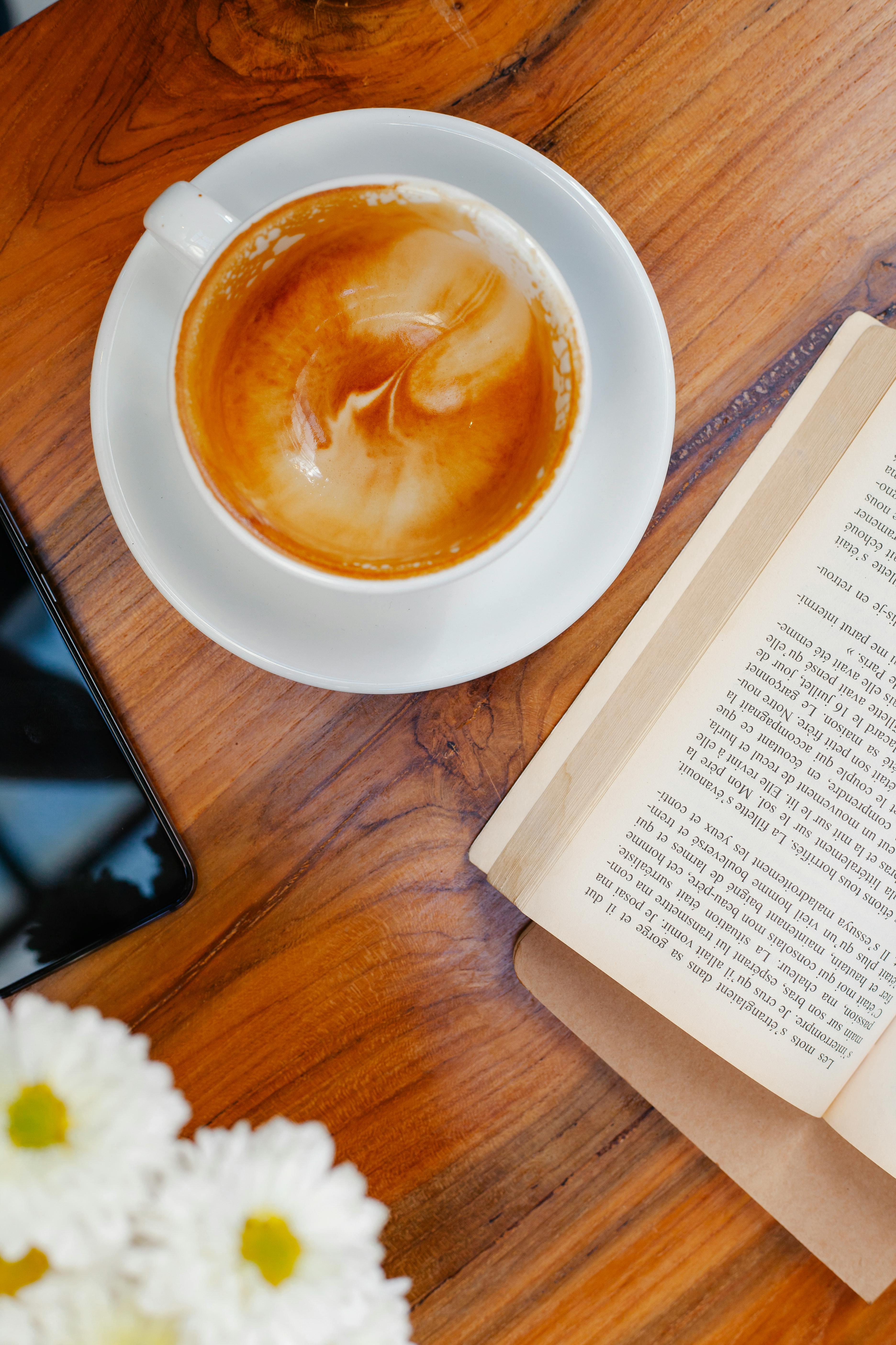 Delicious coffee near book and blooming Chrysanthemums on table · Free  Stock Photo