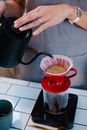 Barista pouring alternative coffee using filter
