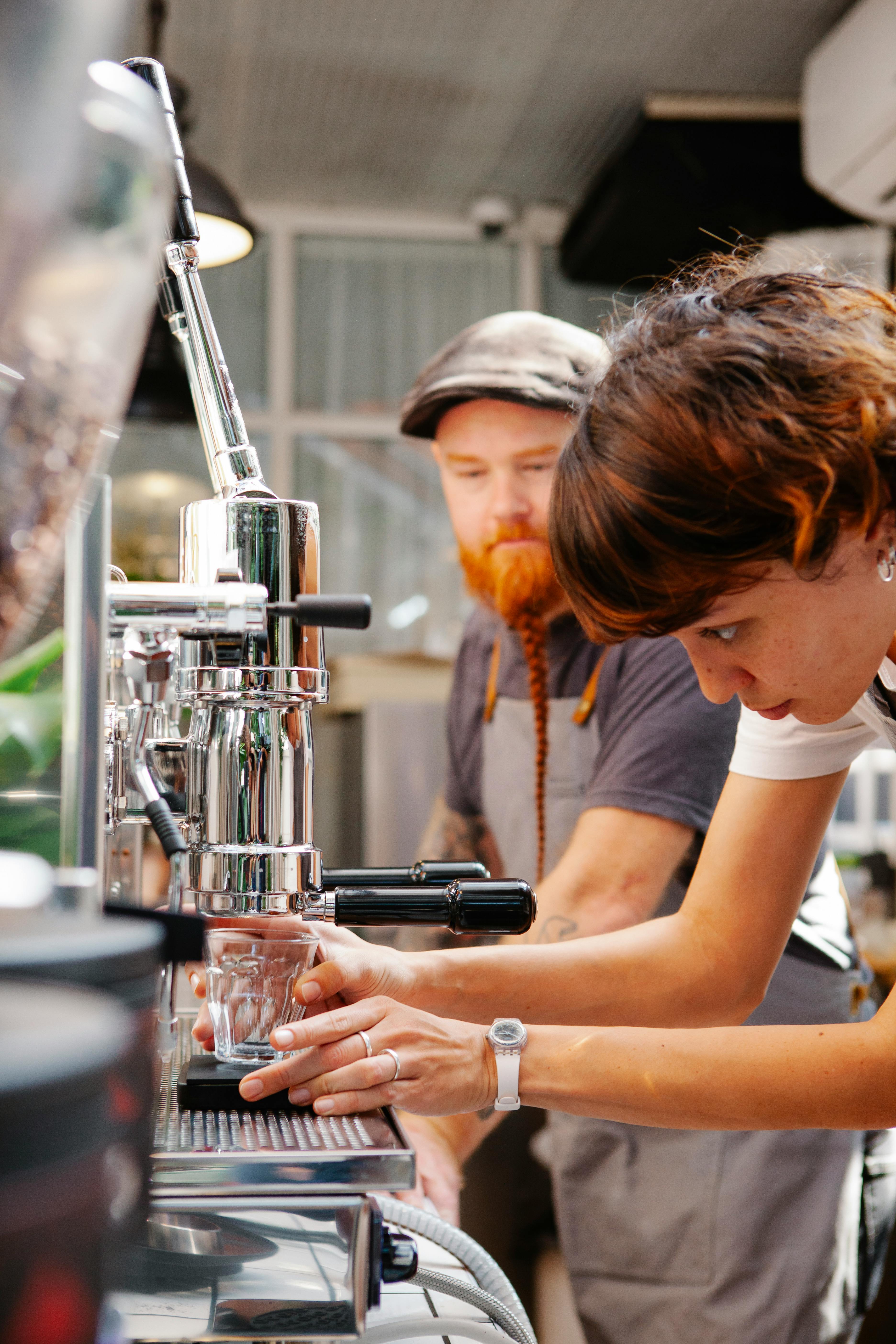 coworkers making coffee in cafe