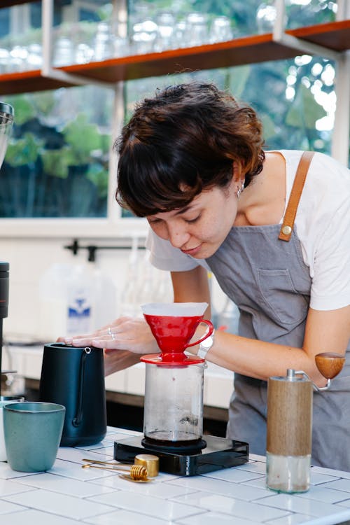 Woman preparing coffee with pour over