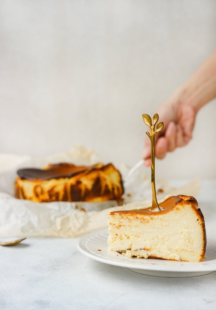 A Slice Of Basque Cheesecake On A Plate 