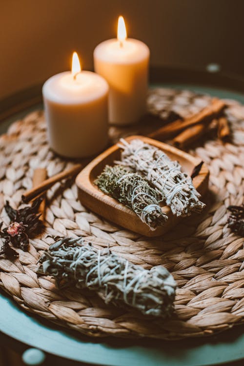 Lit Candles and and Incense in Bundles Lying on a Table 