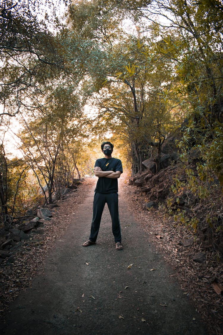 Man Standing On Paved Path