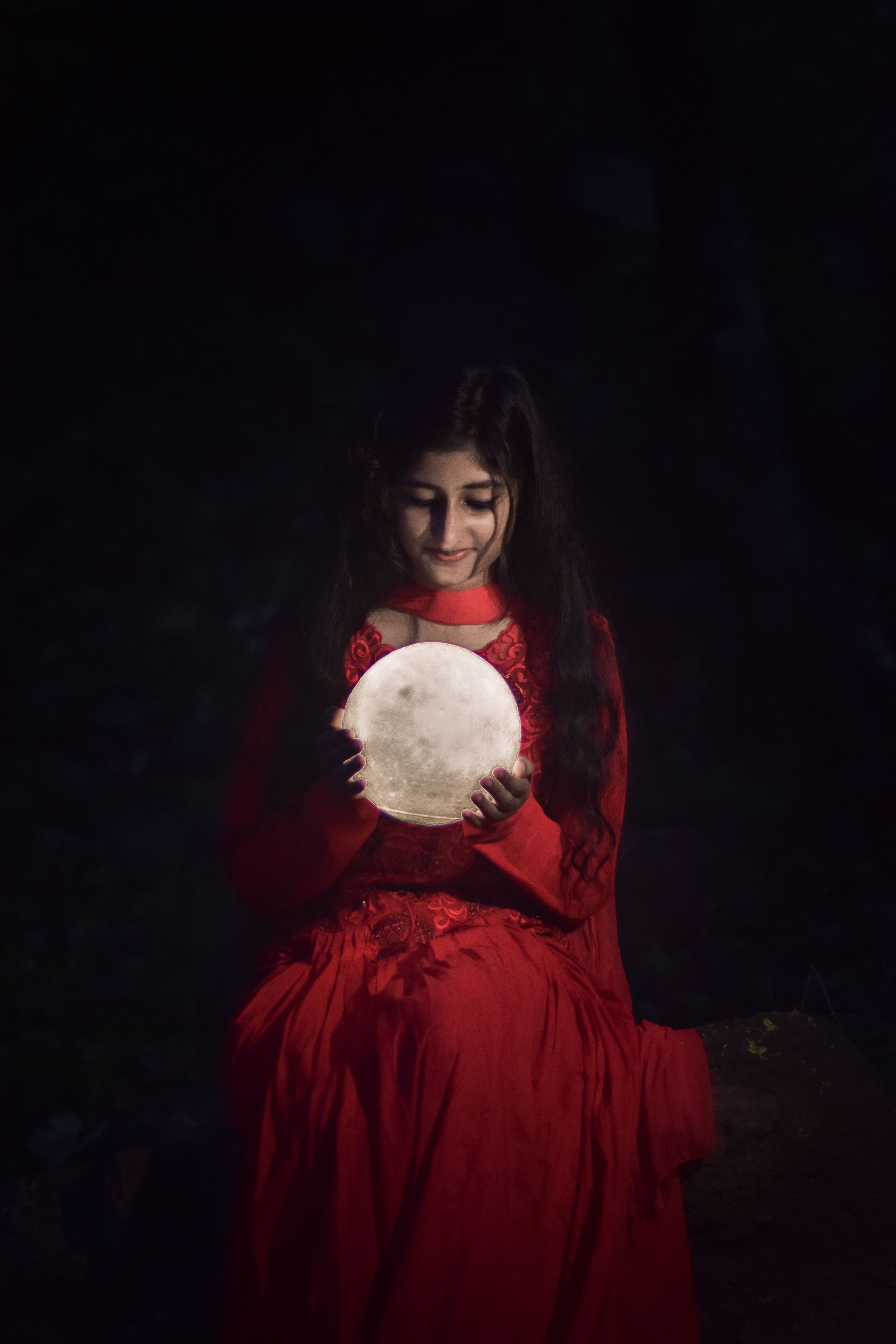 Woman in Red Dress Holding Moon Model · Free Stock Photo