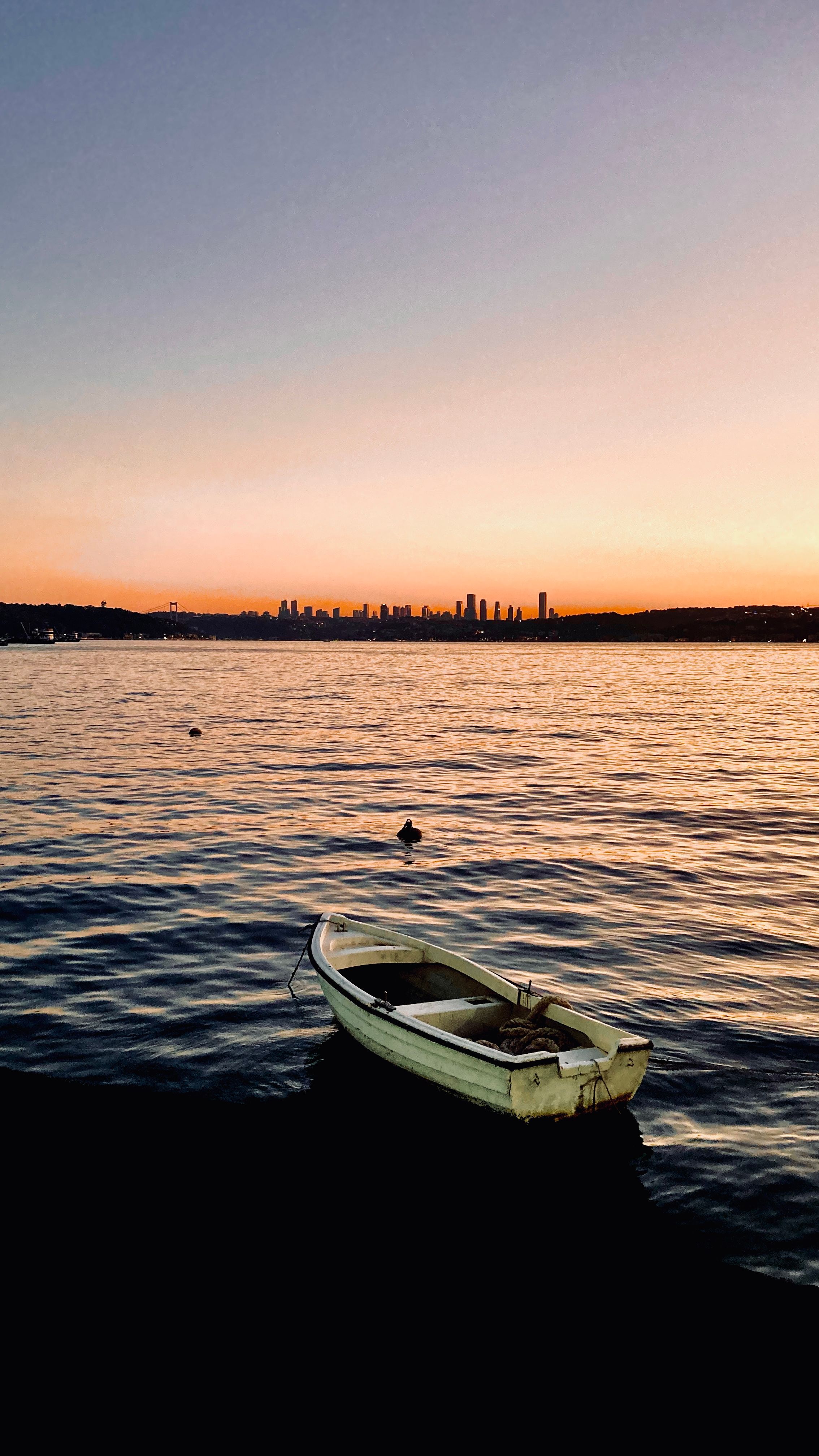 White Boat on Body of Water at Dusk · Free Stock Photo