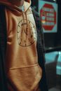 A Person Wearing Orange Hoodie Jacket with Clock Print