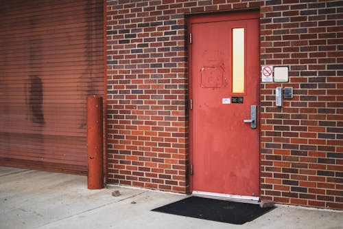 A Red Door Beside the Brick Walls