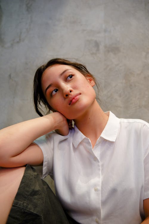 A Pretty Woman in White Button-Up Shirt Posing