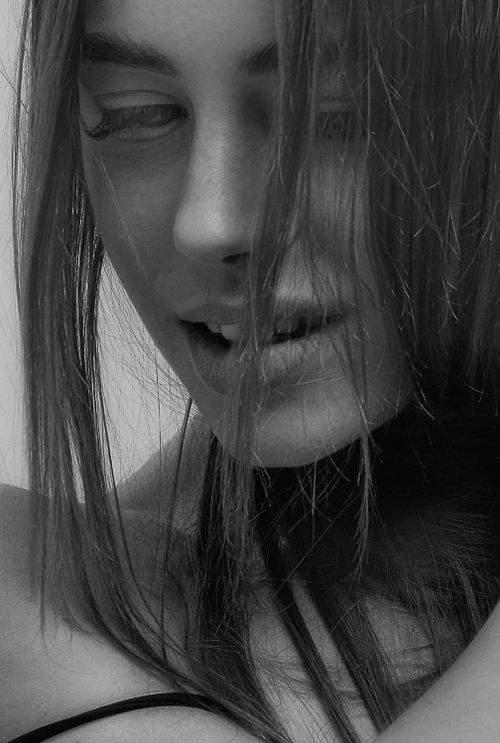 Free Black-and-white close-up portrait of a woman with expressive features. Stock Photo