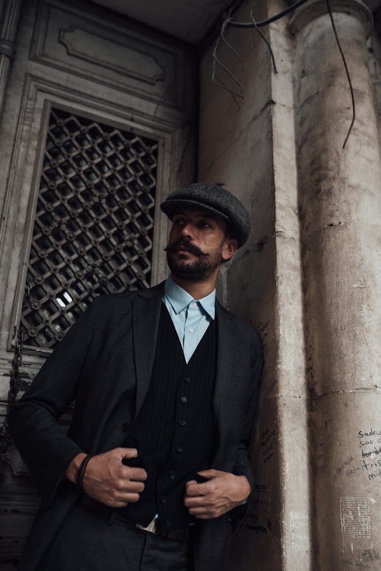 Serious Well Dressed Man Standing Near Stone Mansion Door