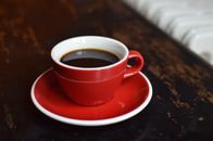 Coffee in cup on table near radiator