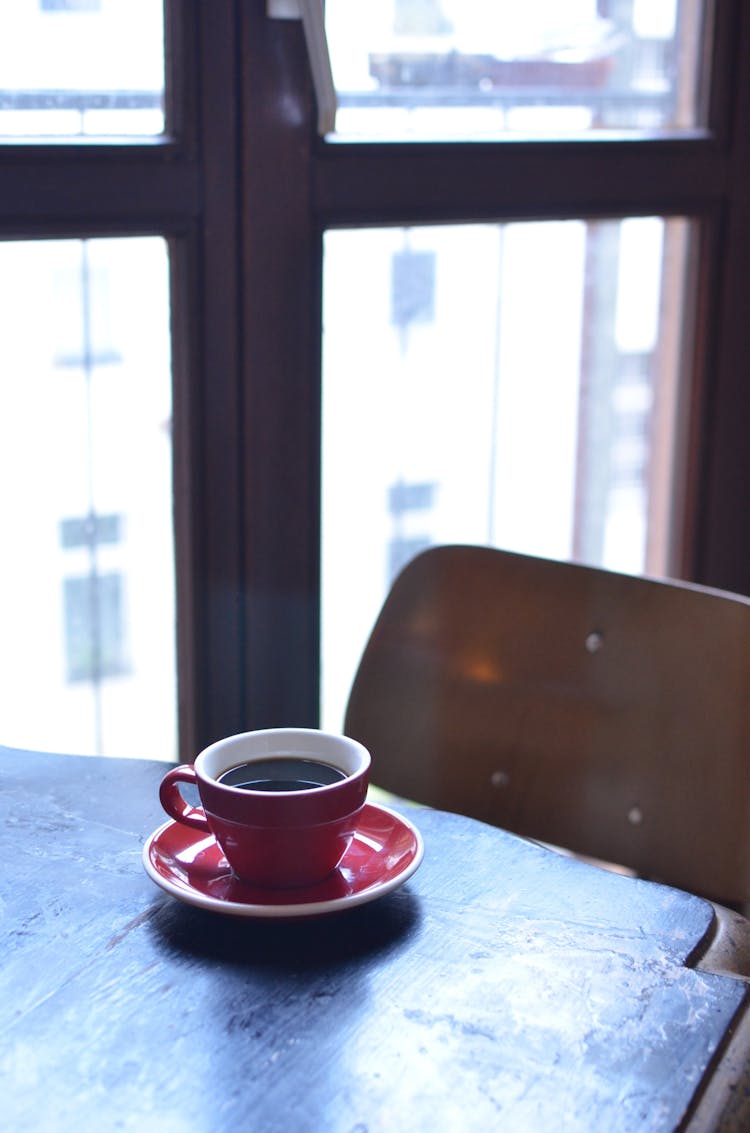 Cup Of Coffee On Table Near Balcony Door