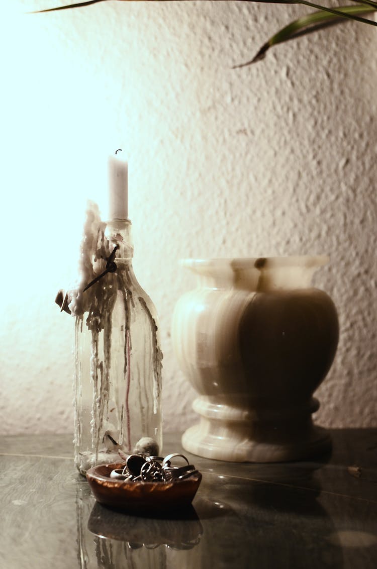 Empty Vase And Candle On Table In Dark Room