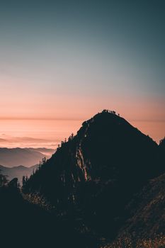 Silhouette of a mountain peak in Türkiye set against a dramatic twilight sky.