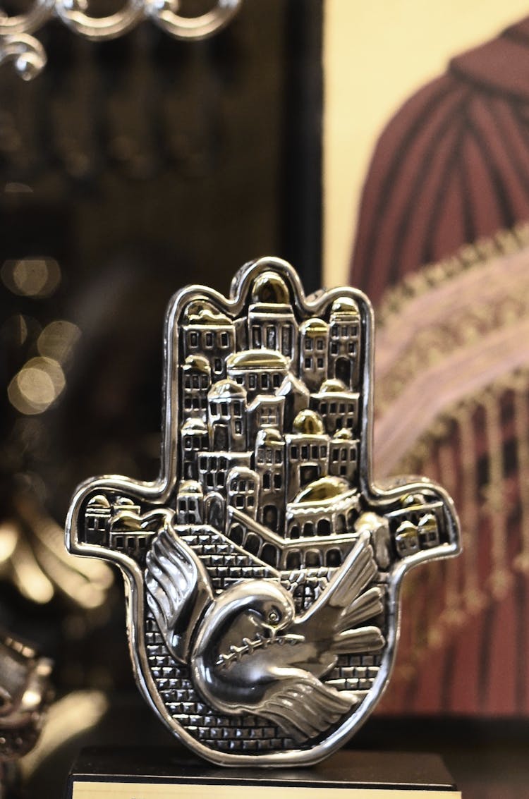 Hamsa With Carved Metal City And Bird Illustrations