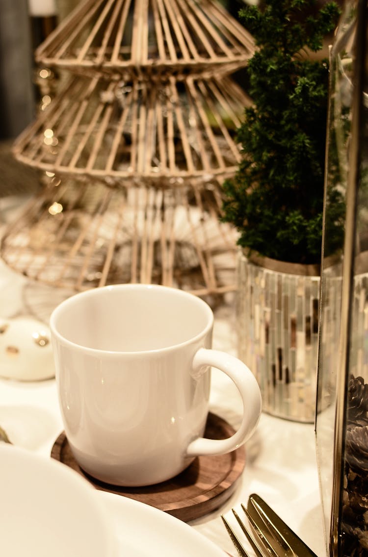 Ceramic Mug Near Small Christmas Tree On Table