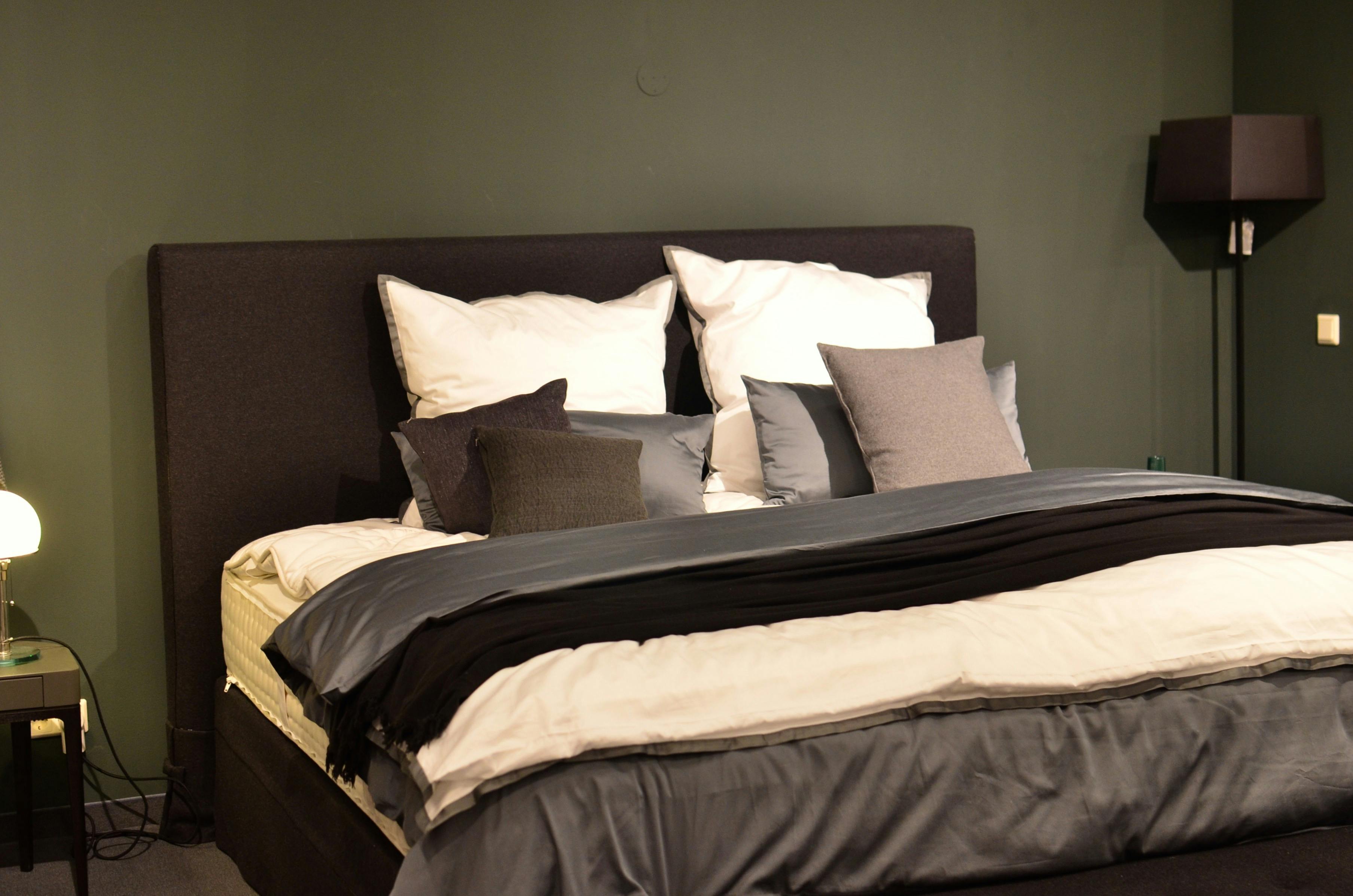 modern bedroom interior with assorted pillows on bed