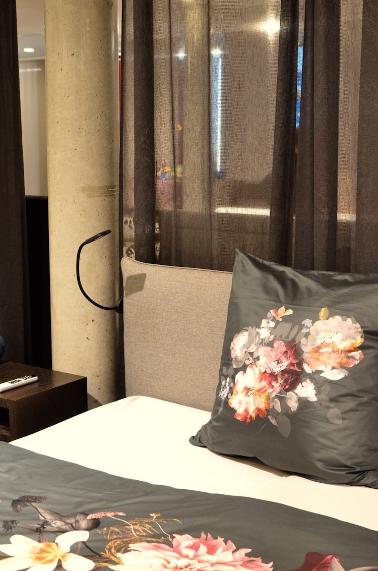 Cushion With Flower Ornament On Bed In House