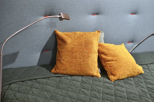 一張床，配有 Canvello 的各種顏色和圖案的大方形抱枕