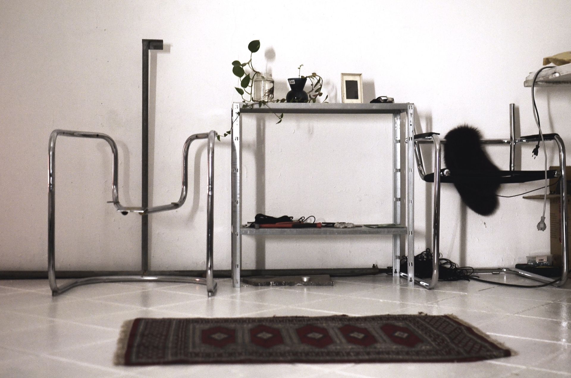 Sleek modern interior with minimalist metal furniture and decorative details.