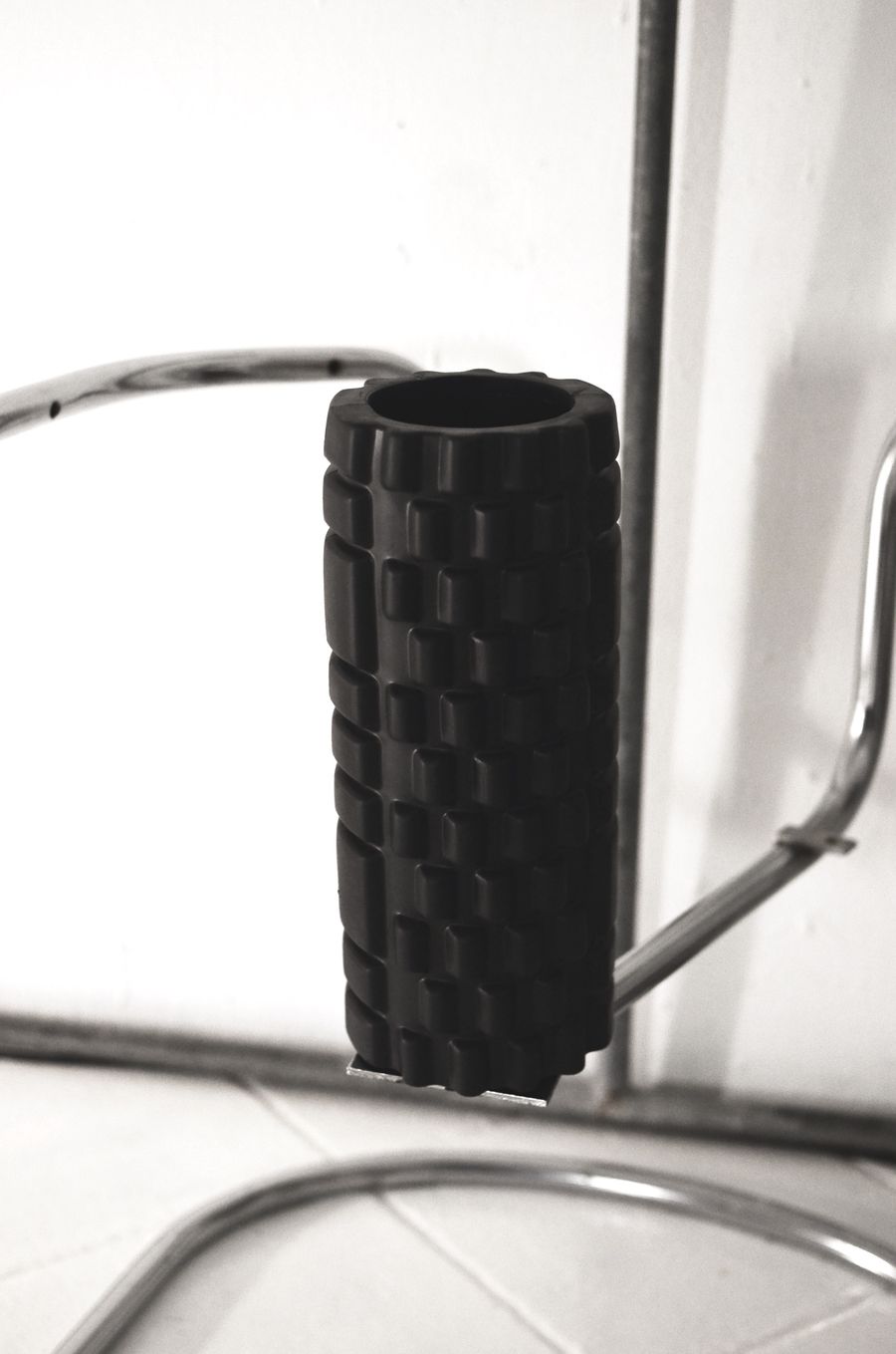 Black textured foam roller prepared for self-massage