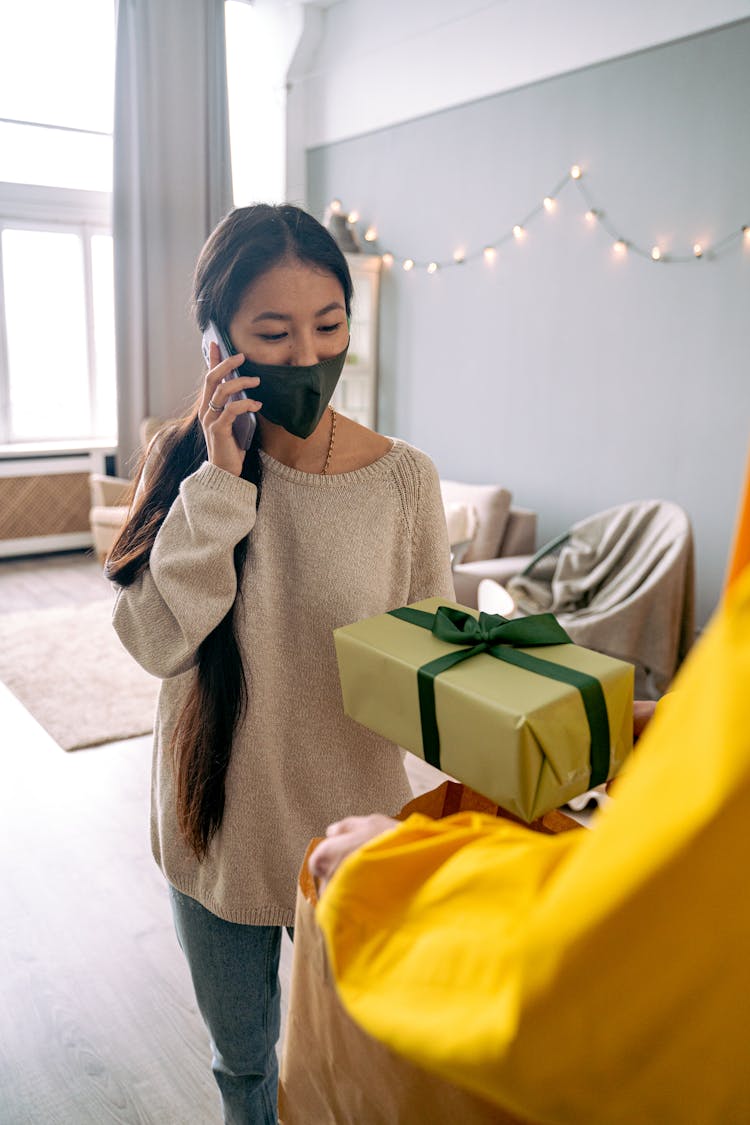 Woman Talking On Phone With Gift Box