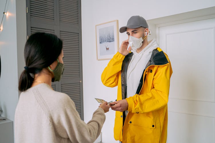 Man Giving Money To Woman