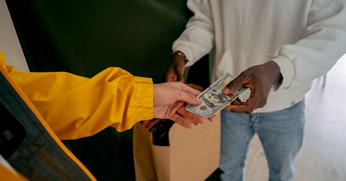 Close up of a Person Paying in Cash · Free Stock Photo