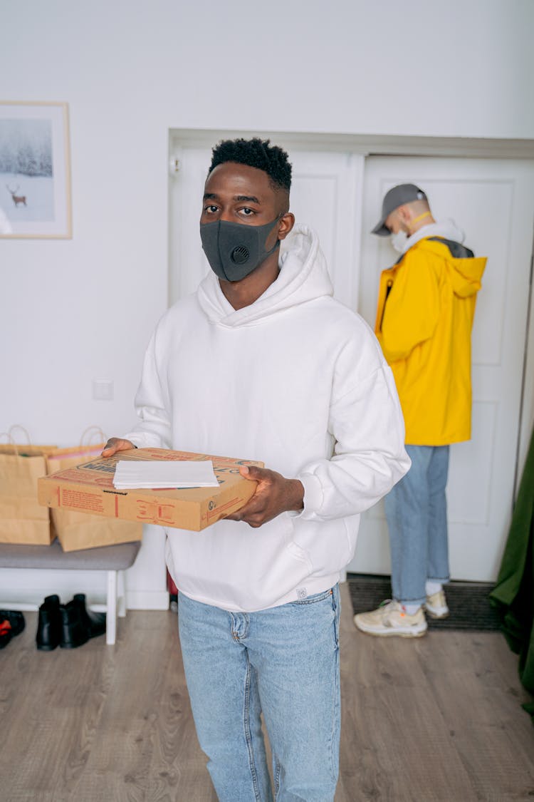 Courier In Face Mask Delivering Food