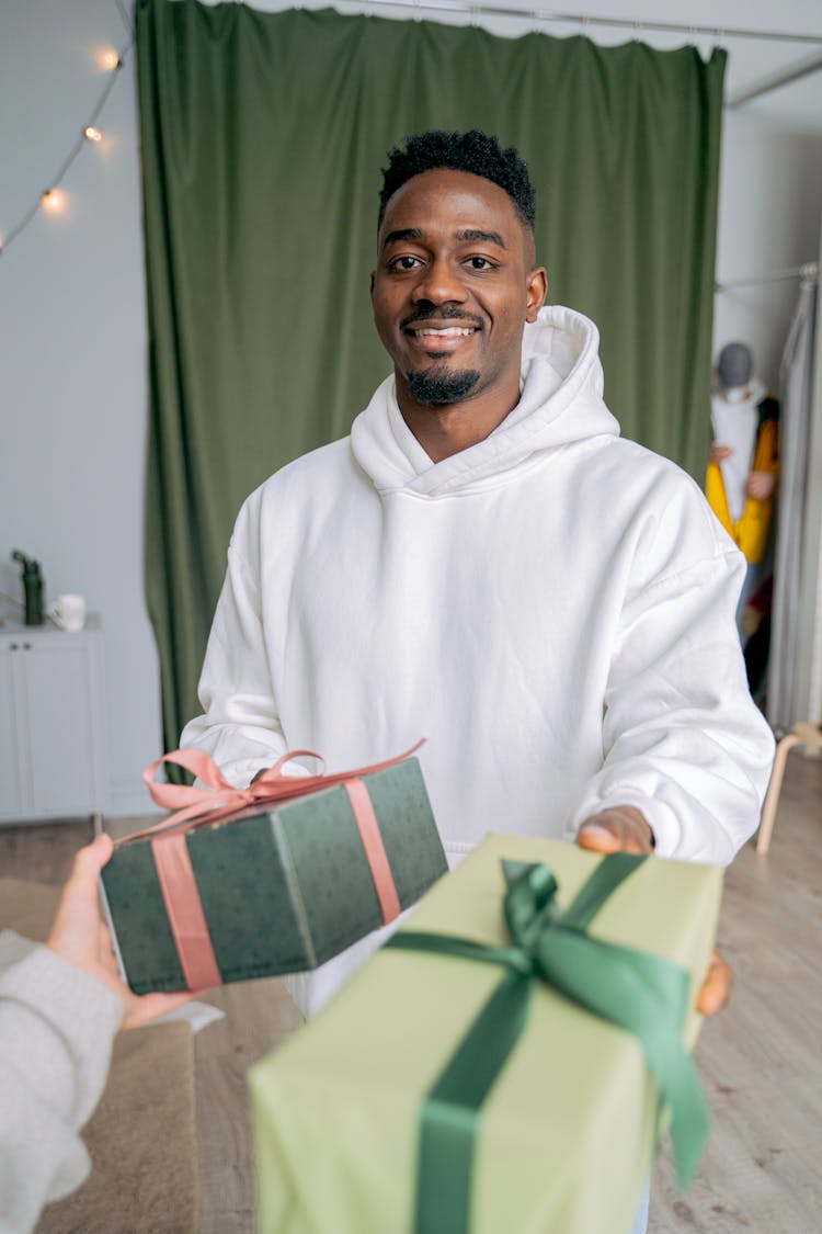 Man Exchanging Gifts With Person