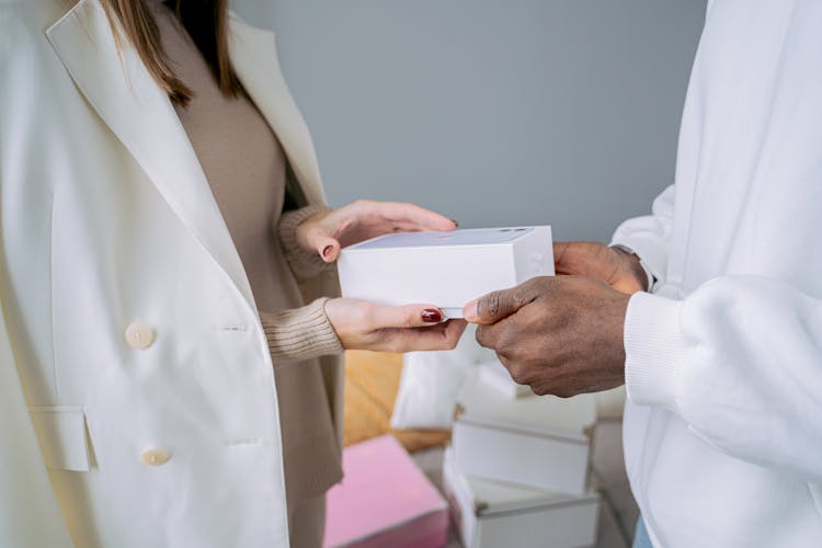 Woman And Man Holding A Box With A Smart Phone 