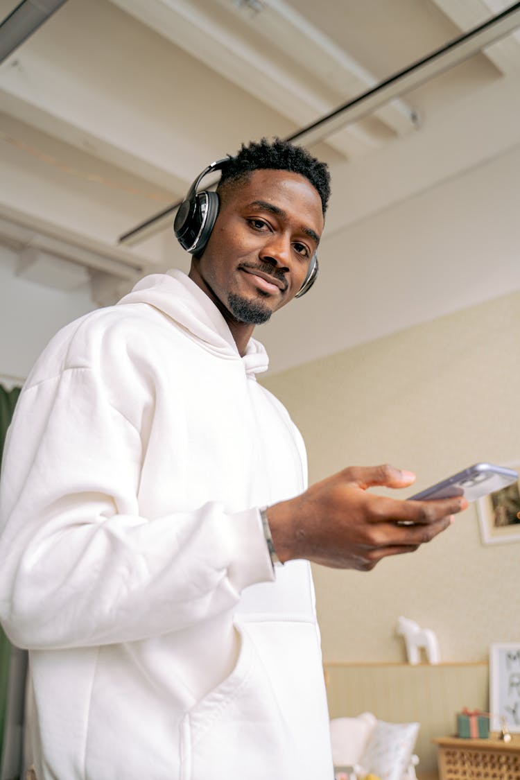 Man In Headphones Using Mobile Phone