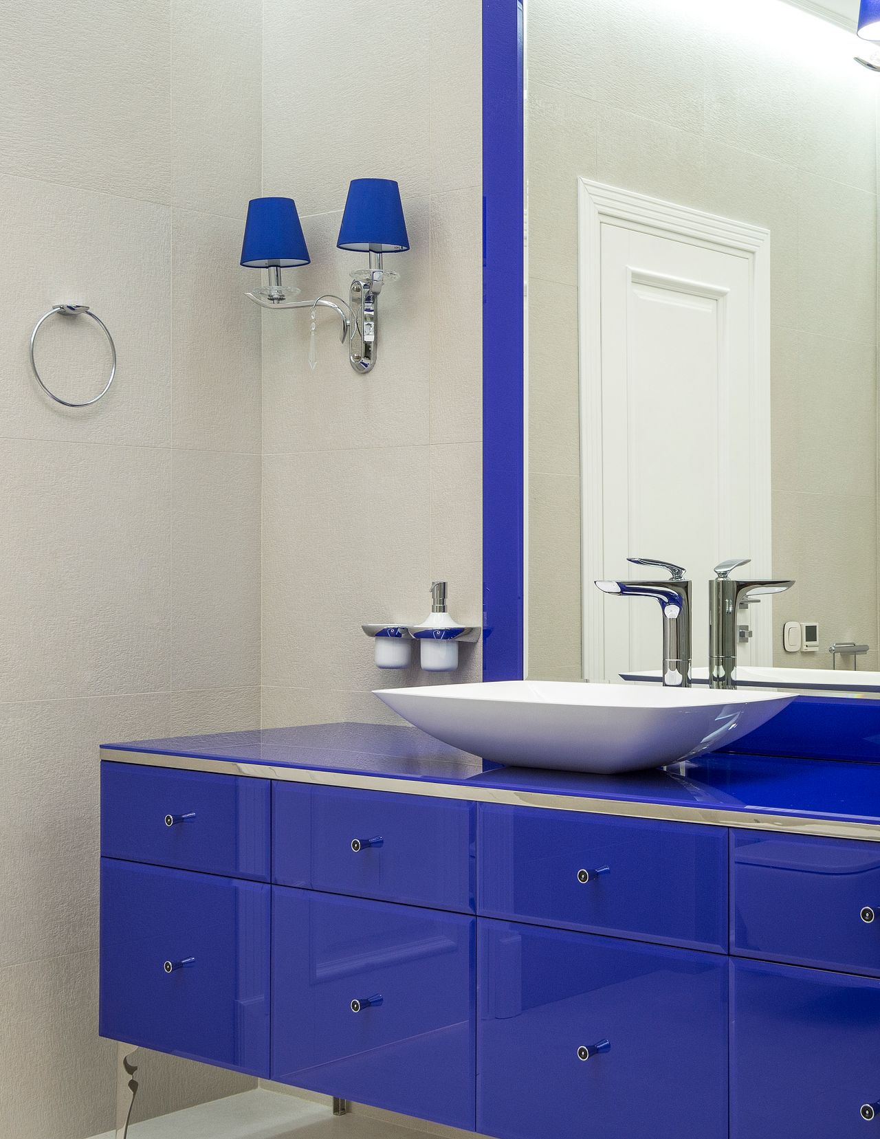 navy-blue-bathroom-vanity Bold blue bathroom vanity against a blue wall